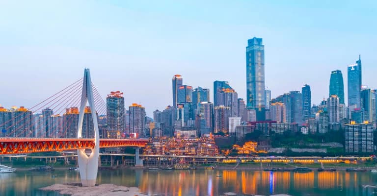 Chongqing cityscape with layered buildings, bridges, and dramatic night skyline