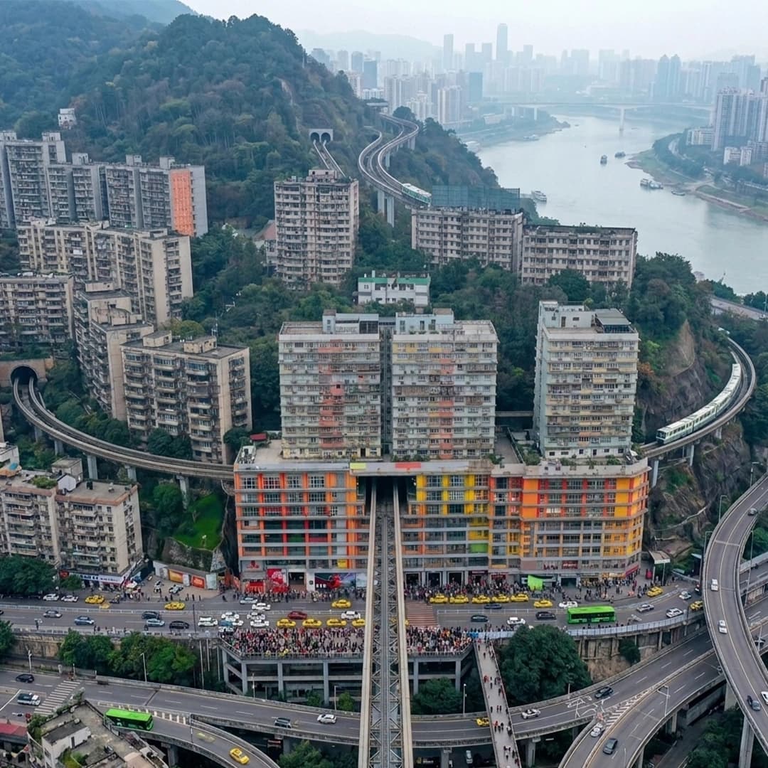 Liziba Station Chongqing with train passing through a residential building and urban surroundings