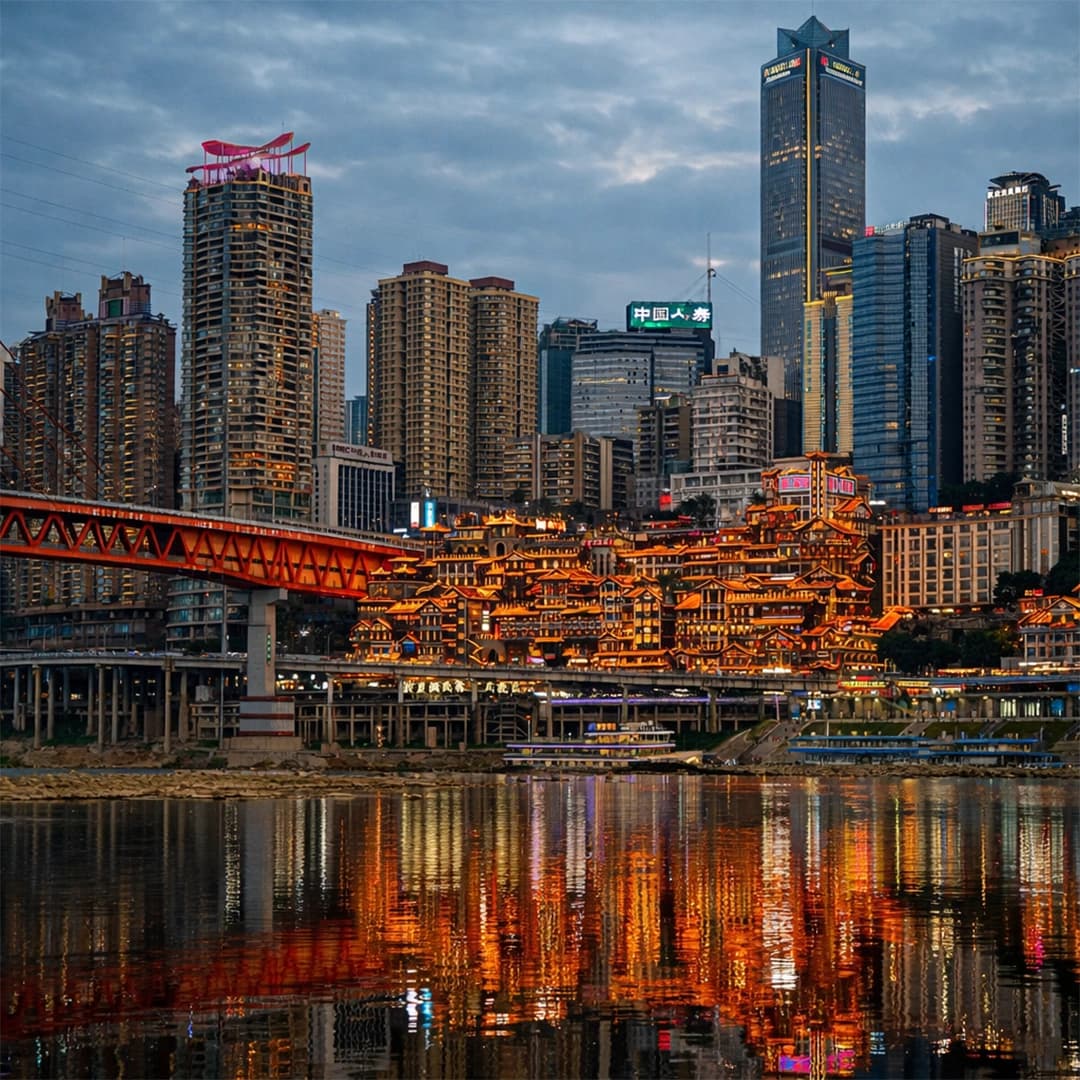 Hongya Cave Chongqing illuminated at night with traditional stilt buildings along the riverfront