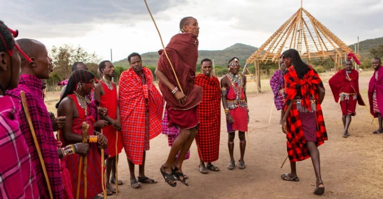 Maasai tribe cultural experience in Kenya with traditional attire, dance, and village interaction
