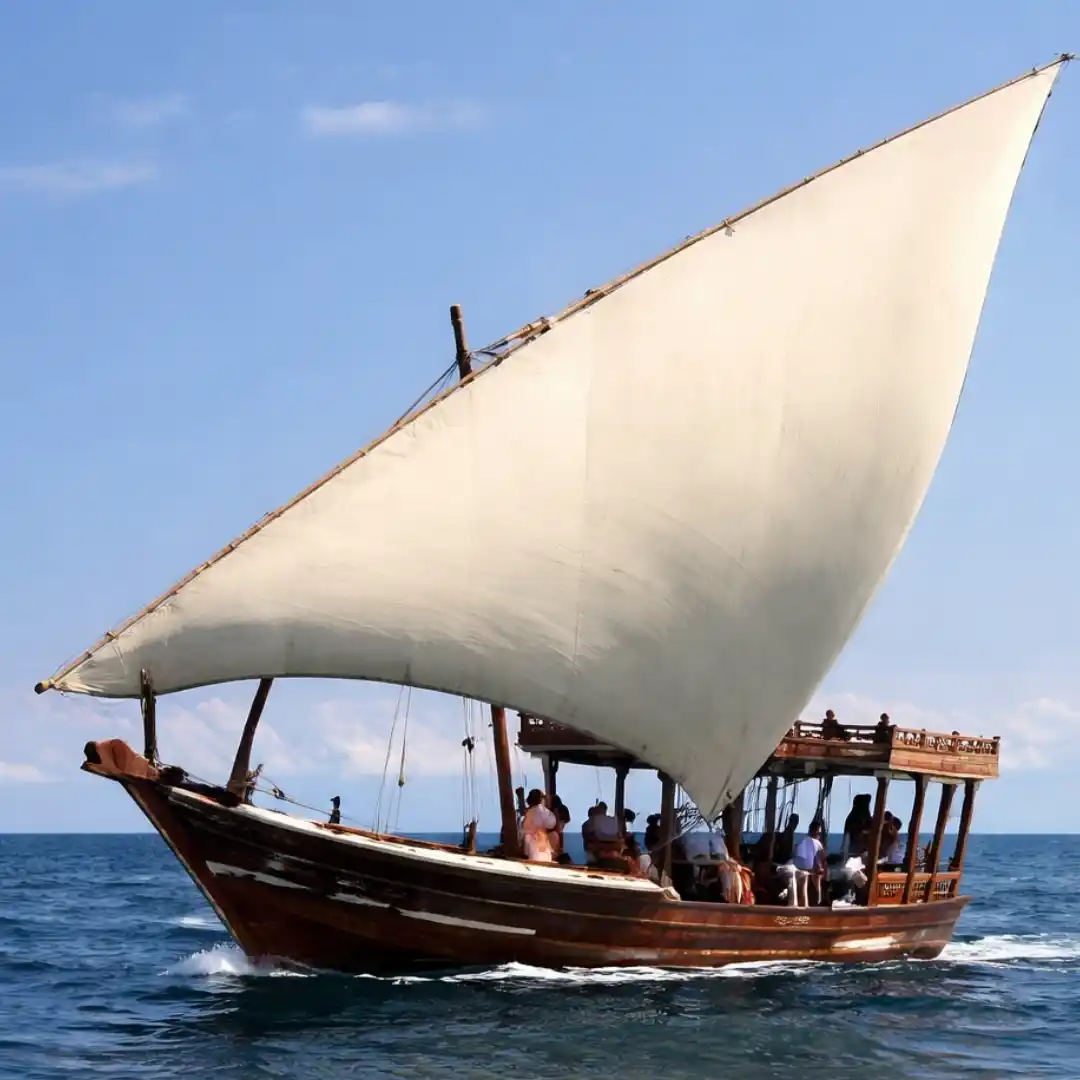 Traditional dhow boat sailing at sunset along the Kenyan coast