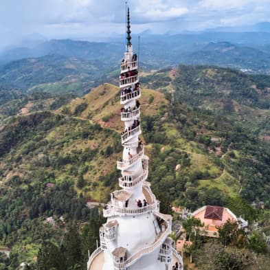 Ambuluwawa Tower rising above forests and mountain scenery