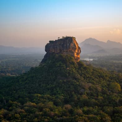 Sigiriya Rock Fortress rising above lush landscapes in central Sri Lanka