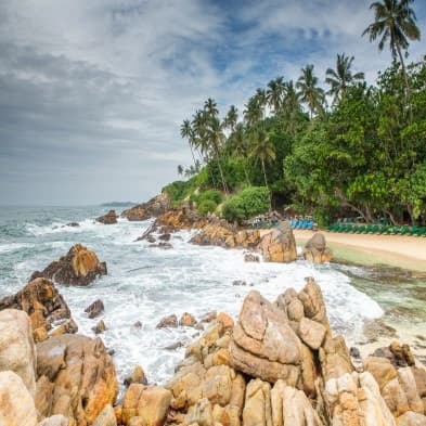 Surf-friendly shoreline at Weligama Beach in Sri Lanka