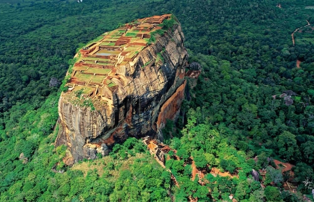 Sigiriya Rock Fortress rising above lush greenery in Sri Lanka