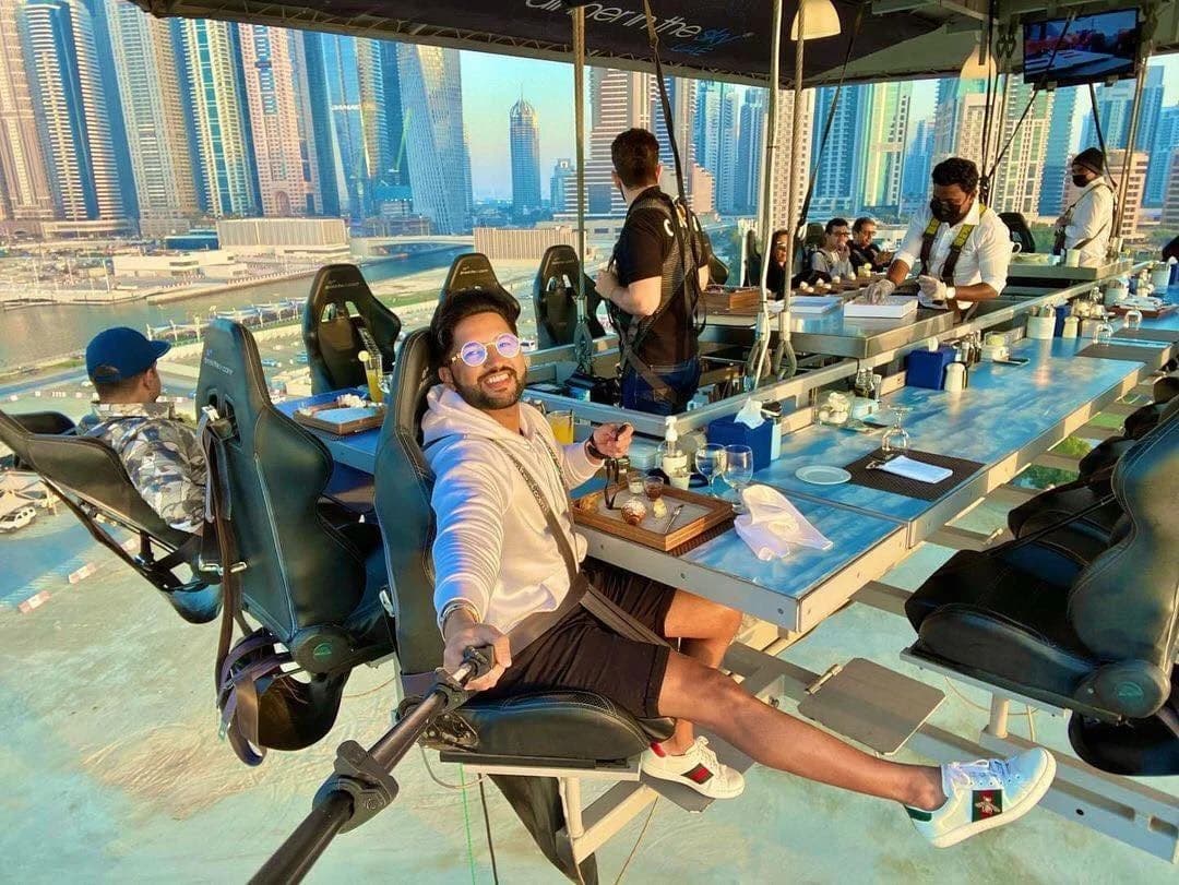 Guests dining on Dinner in the Sky experience overlooking Dubai skyline