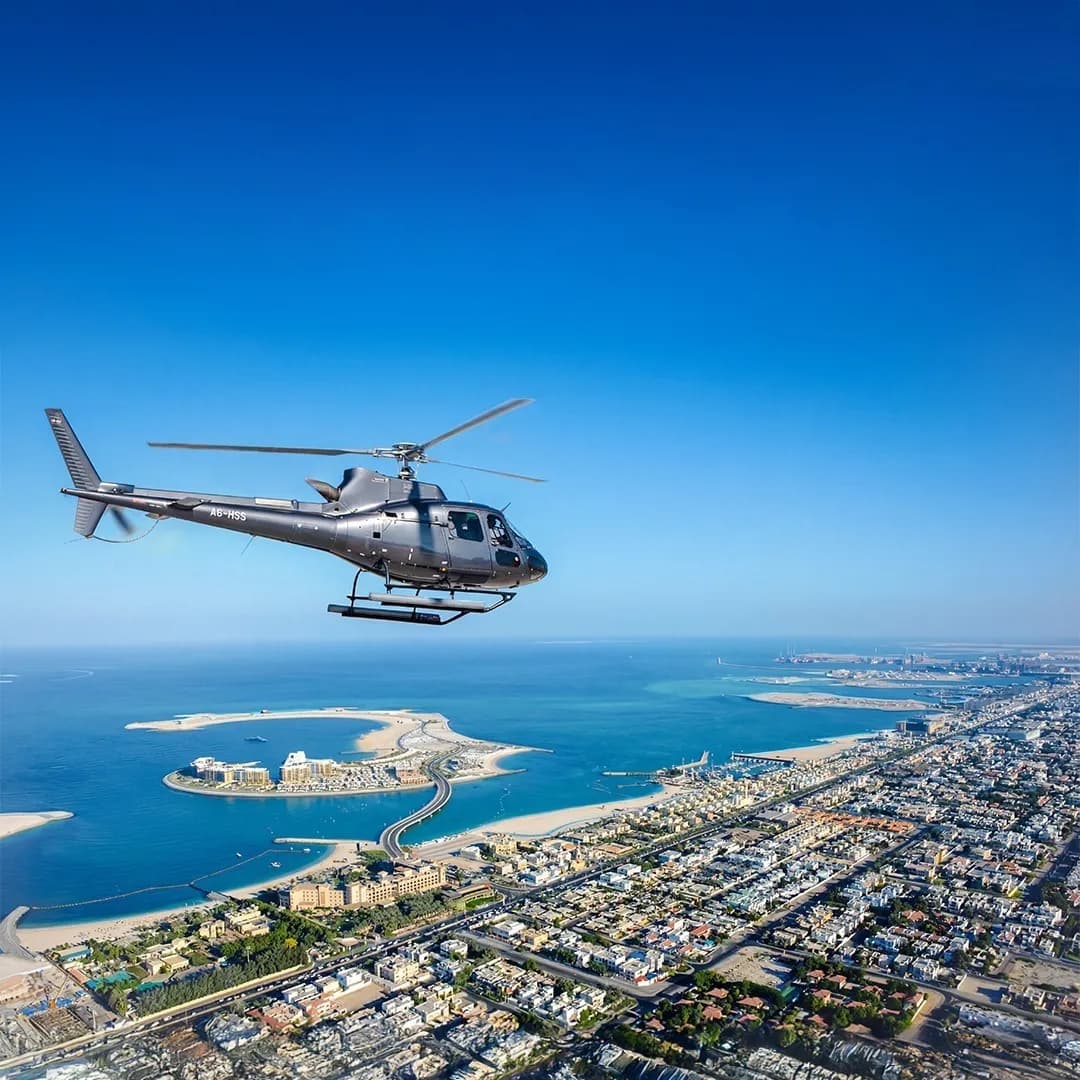 Helicopter flying over Dubai skyline with Burj Khalifa and Palm Jumeirah aerial view