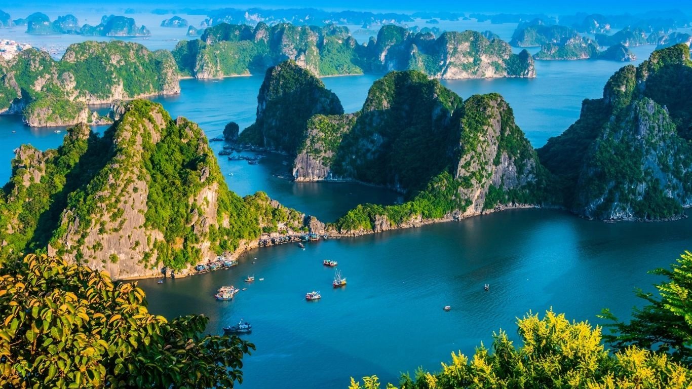 Vietnam travel package featuring Halong Bay cruises, Hoi An lantern streets, Bana Hills Golden Bridge, and vibrant Ho Chi Minh City experiences